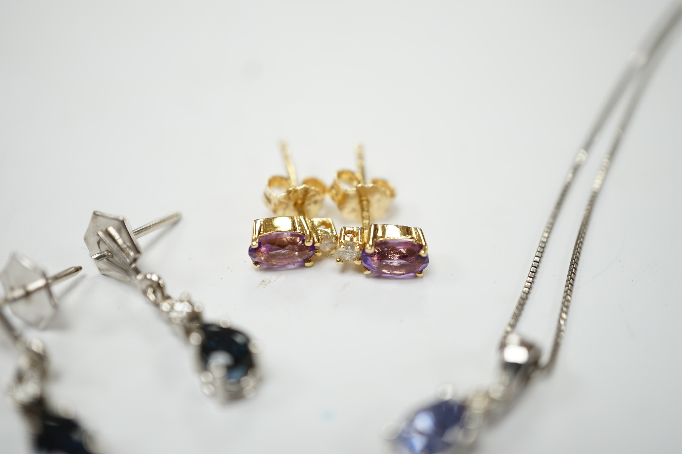 A modern 18ct white gold sapphire and diamond set drop pendant, 13mm, on a 925 chain, together with a modern pair of 750 yellow metal, amethyst and diamond set ear studs and a pair of 9ct sapphire and diamond set ear stu